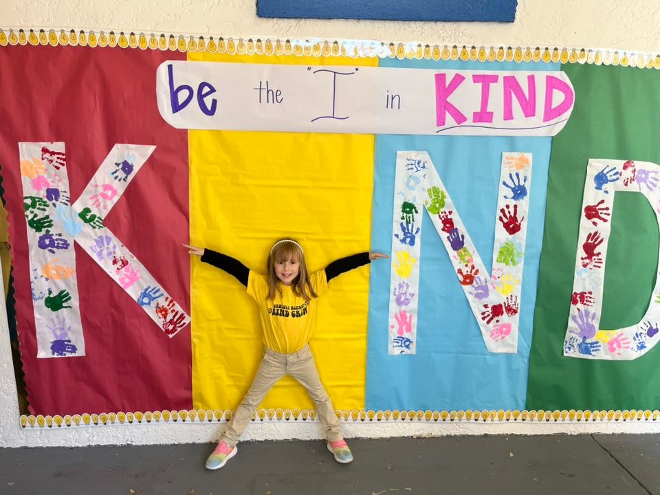 Kid in front of Kind Crew poster